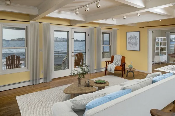 a living room with furniture and large windows