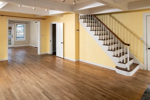 a view of an entryway with wooden floor