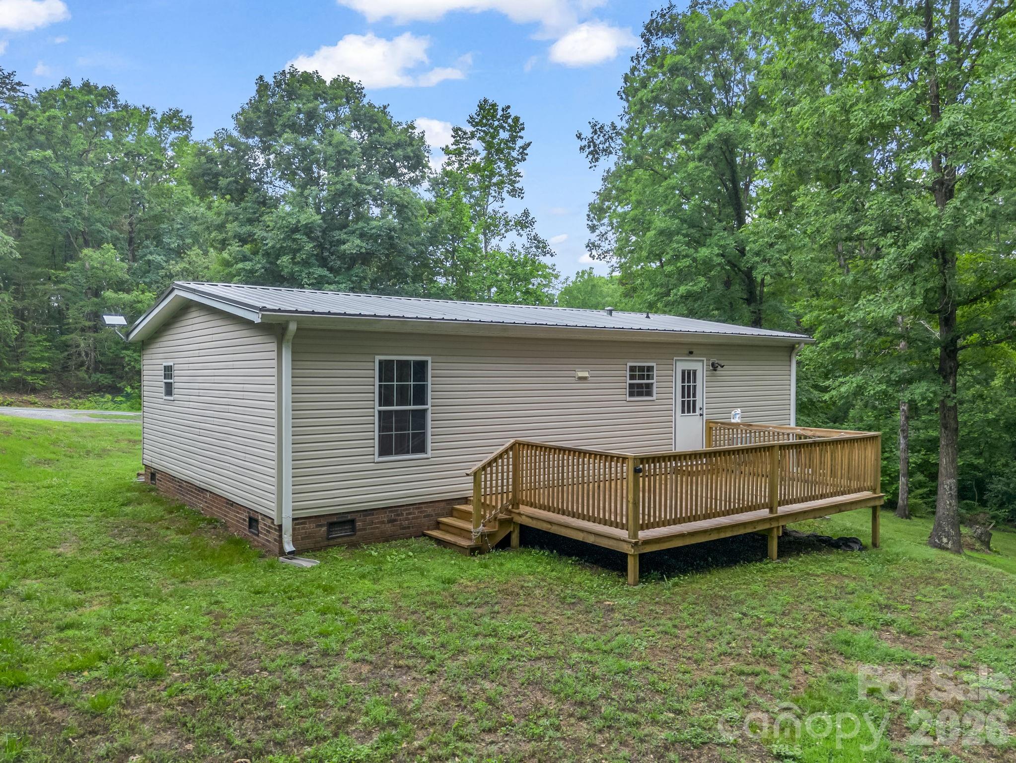 1449 Toney Road Bostic, NC 28018 - Photo 11 of 43 a view of a house with a yard and a wooden deck