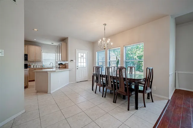 a view of a dining room with furniture and chandelier