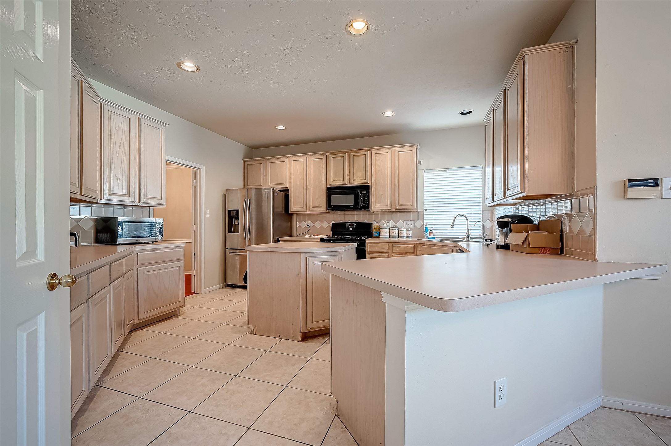 2907 Little Branch Court Houston, TX 77082 - Photo 17 of 50 a kitchen with cabinets and stainless steel appliances