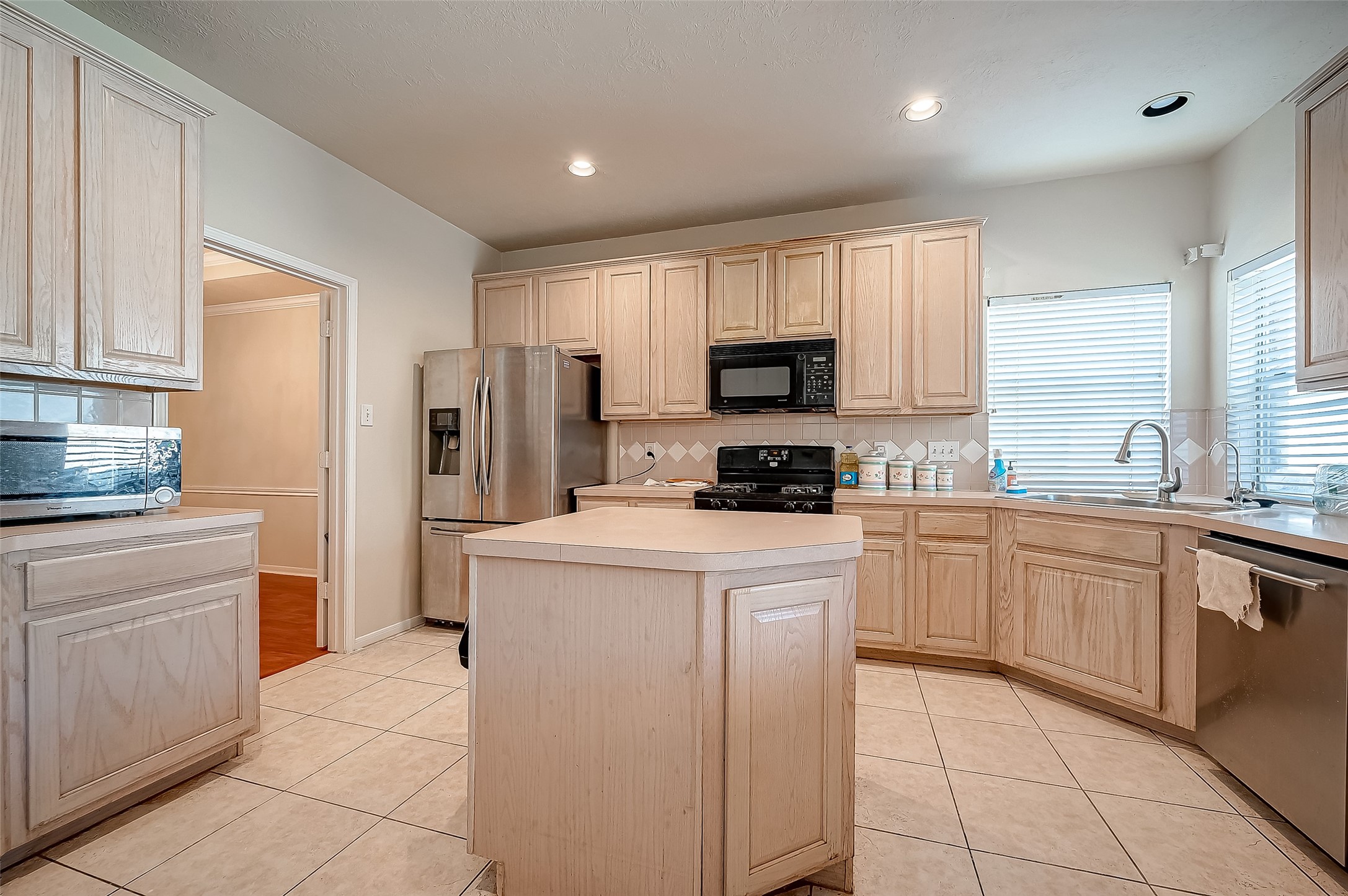 2907 Little Branch Court Houston, TX 77082 - Photo 18 of 50 a kitchen with cabinets appliances a sink and a counter top space
