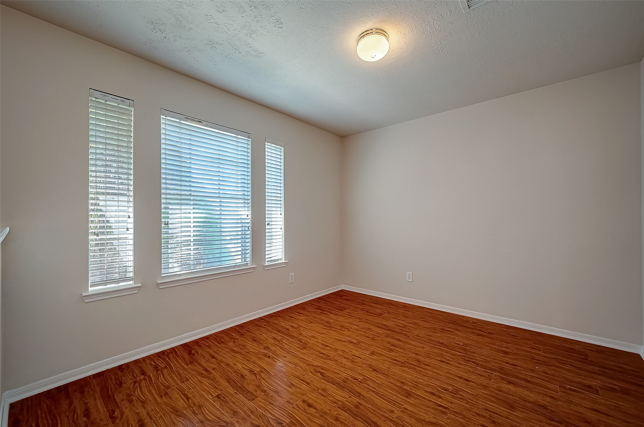 2907 Little Branch Court Houston, TX 77082 - Photo 24 of 50 an empty room with wooden floor and windows