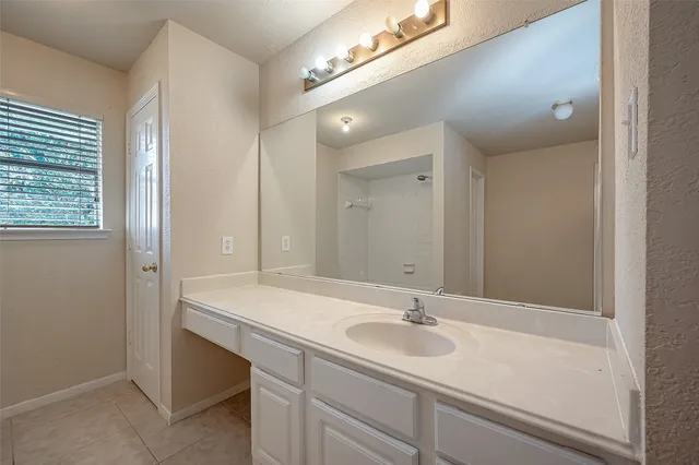 a bathroom with a sink double vanity and a mirror