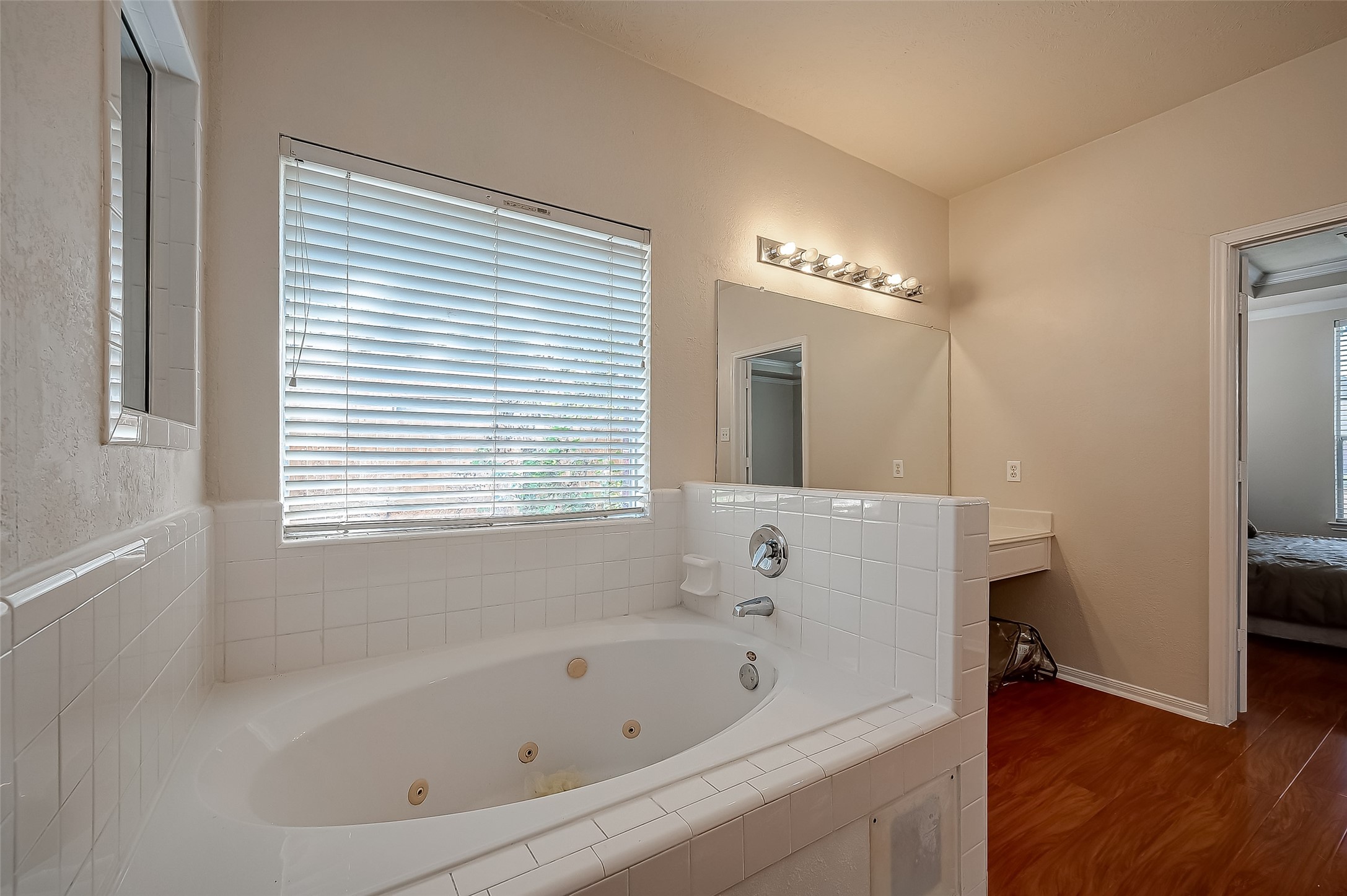 2907 Little Branch Court Houston, TX 77082 - Photo 44 of 50 a bathroom with a bathtub a table and a window