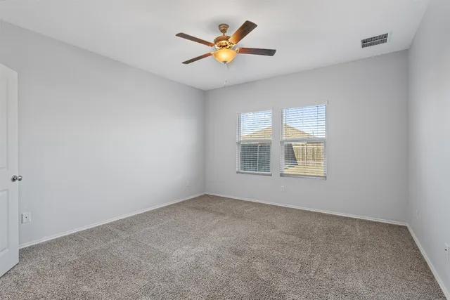 a view of a livingroom with wooden floor and a ceiling fan