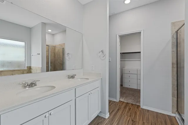 an empty room with window and ceiling fan