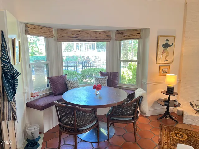 a dining room with furniture a chandelier and wooden floor
