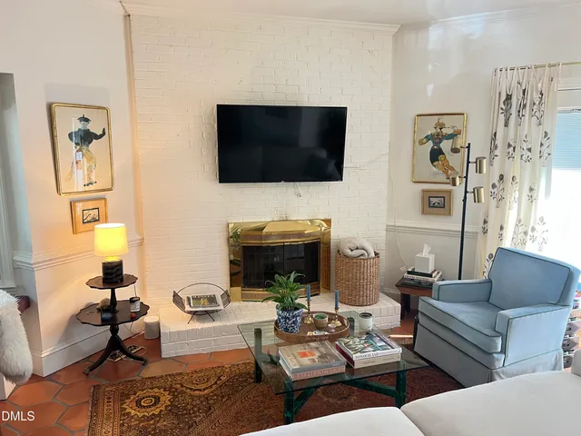 a living room with fireplace furniture and a flat screen tv