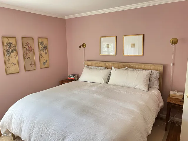 a large bed with a white comforter and pillows