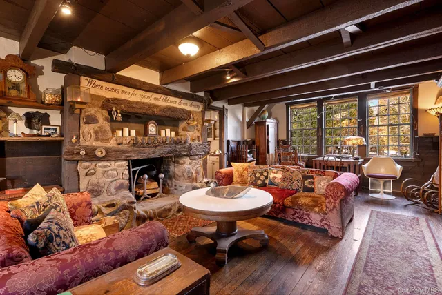 a living room with furniture a fireplace and a table