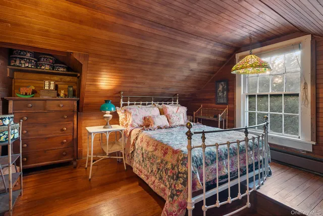 a bedroom with furniture and a window