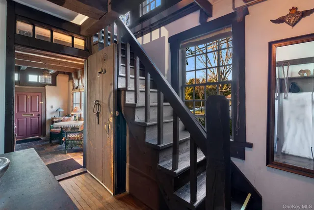 a view of an entryway with wooden floor and livingroom