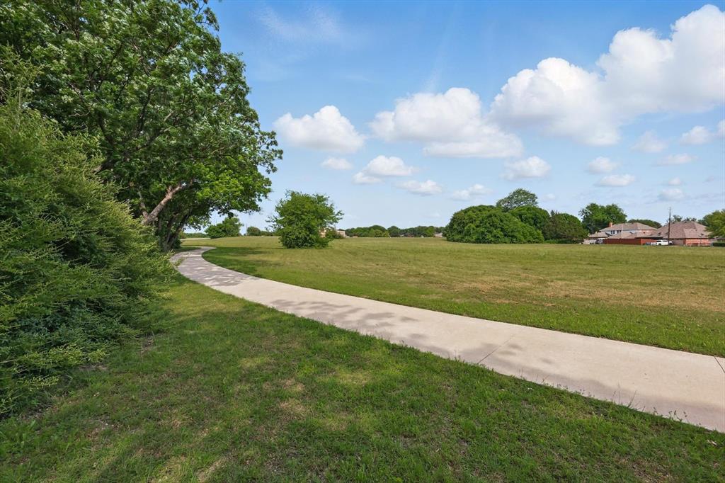 699 West Wintergreen Road DeSoto, TX 75115 - Photo 10 of 29 a view of a lake with a big yard