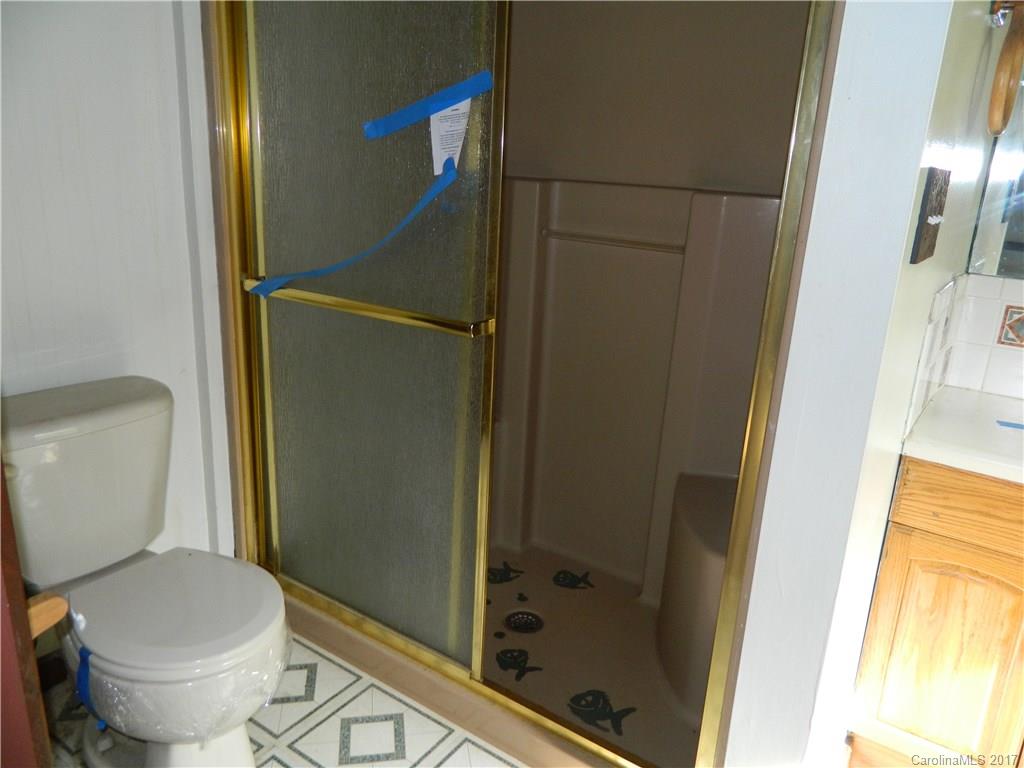 1111 McCurdy Road Hiddenite, NC 28636 - Photo 11 of 20 a bathroom with a toilet and a shower