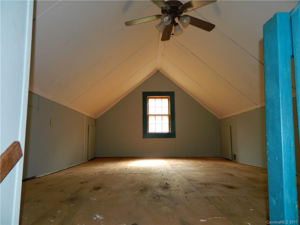 1111 McCurdy Road Hiddenite, NC 28636 - Photo 14 of 20 a view of a big room with a ceiling fan and a window