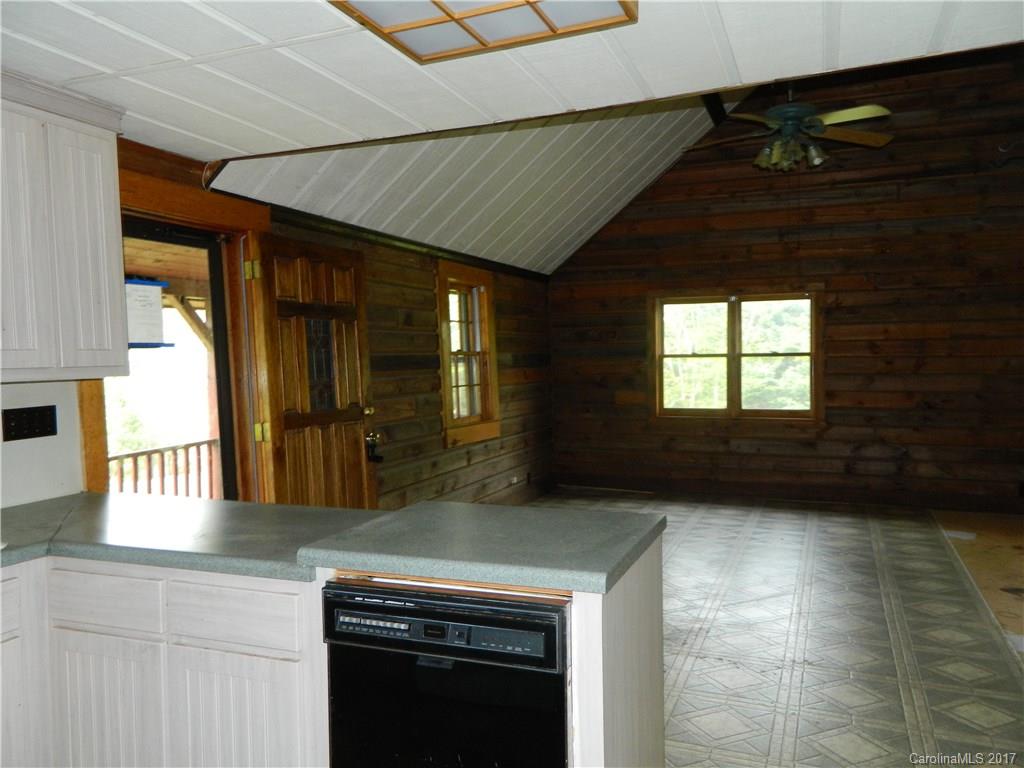 1111 McCurdy Road Hiddenite, NC 28636 - Photo 4 of 20 a kitchen with granite countertop a stove a sink and a microwave