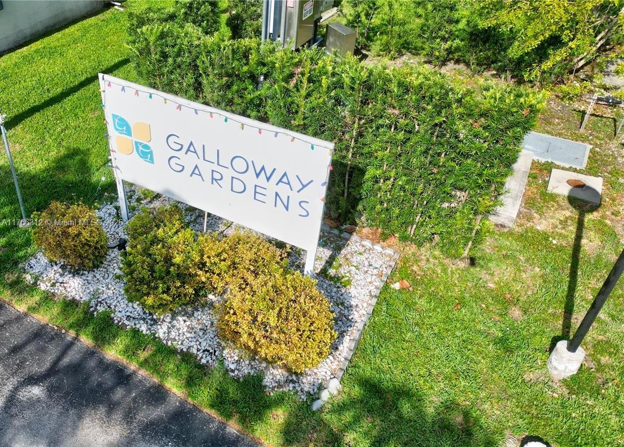 8788 Southwest 12th Street, Unit 103 Miami, FL 33174 - Photo 15 of 15 a sign broad in front of flowers