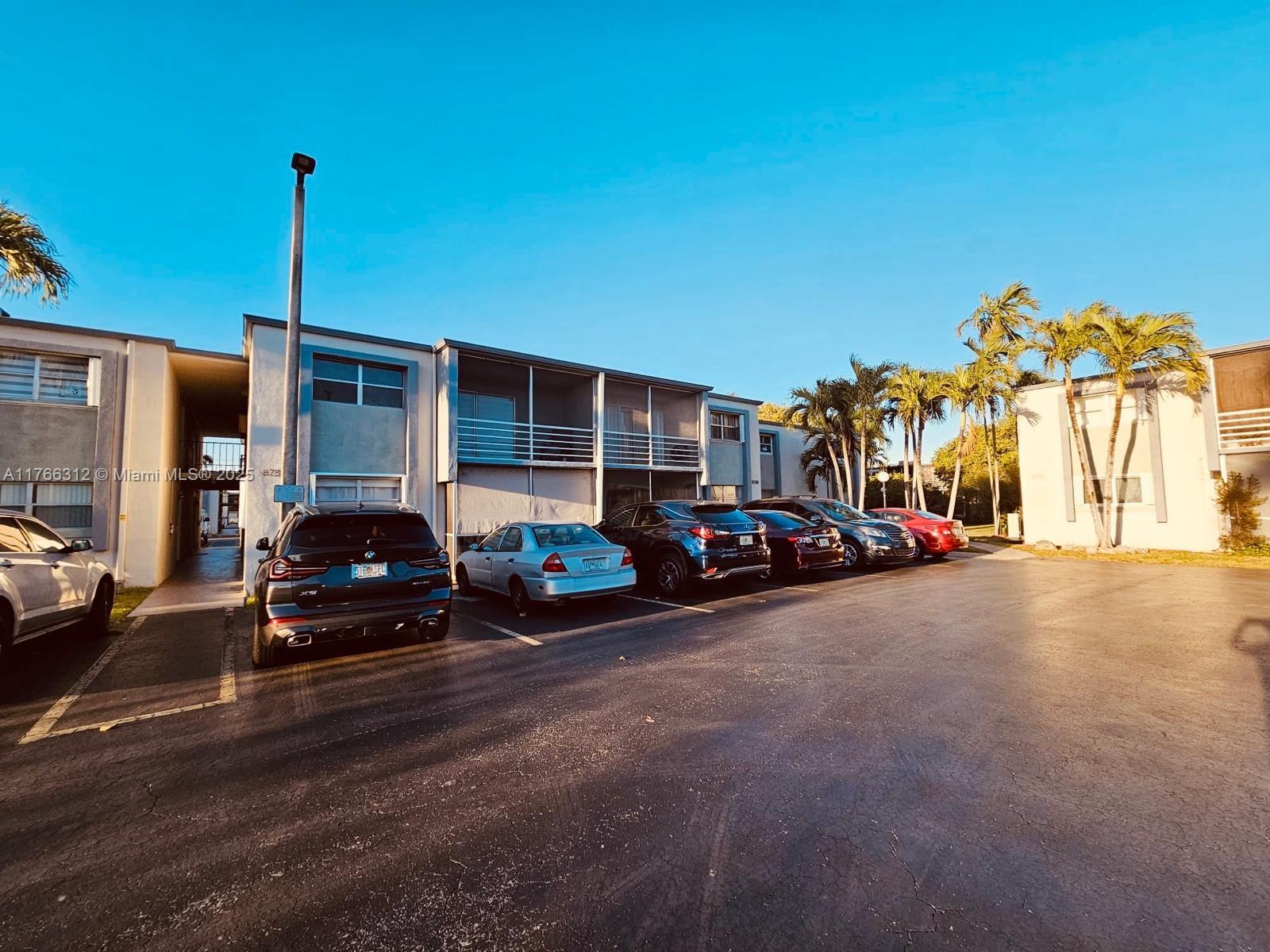 8788 Southwest 12th Street, Unit 103 Miami, FL 33174 - Photo 2 of 15 a view of street with parked cars