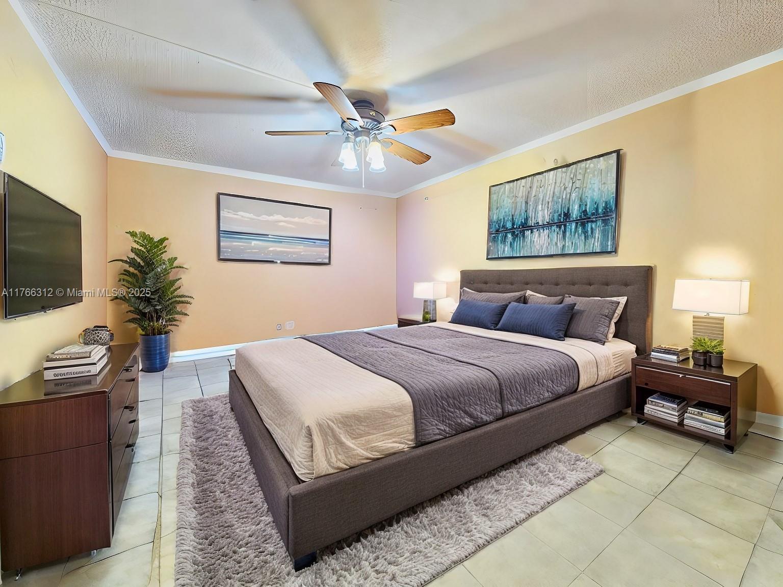 8788 Southwest 12th Street, Unit 103 Miami, FL 33174 - Photo 6 of 15 a bedroom with a large bed and a flat screen tv