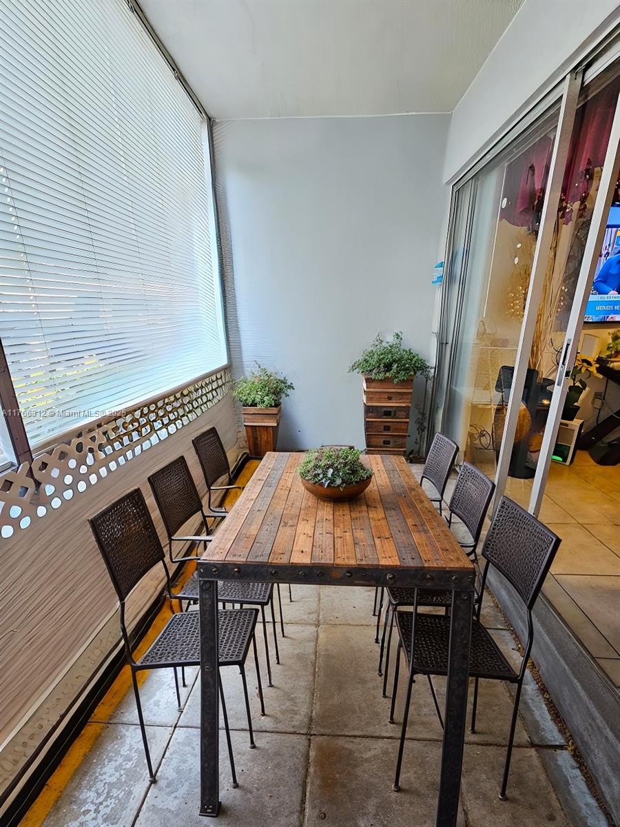8788 Southwest 12th Street, Unit 103 Miami, FL 33174 - Photo 8 of 15 a view of a dining room with furniture and wooden floor
