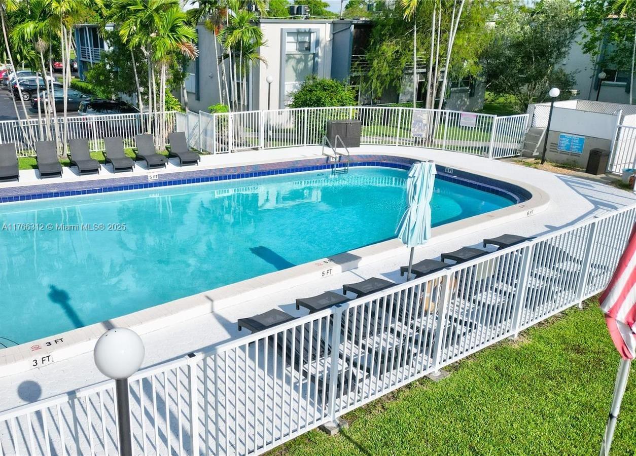 8788 Southwest 12th Street, Unit 103 Miami, FL 33174 - Photo 10 of 15 a view of a wooden deck and a backyard