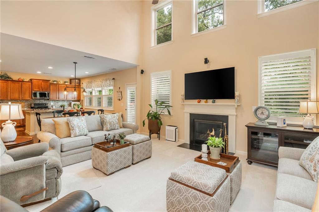 407 Ward Farm Drive Powder Springs, GA 30127 - Photo 13 of 67 a living room with furniture a fireplace and a flat screen tv
