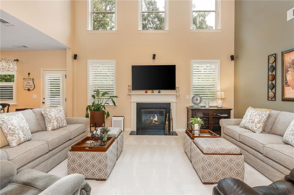 407 Ward Farm Drive Powder Springs, GA 30127 - Photo 14 of 67 a living room with furniture a fireplace and a flat screen tv