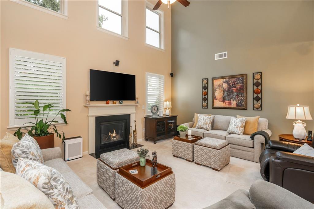 407 Ward Farm Drive Powder Springs, GA 30127 - Photo 18 of 67 a living room with furniture a fireplace and a flat screen tv