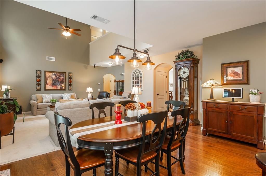 407 Ward Farm Drive Powder Springs, GA 30127 - Photo 26 of 67 a view of a dining room and livingroom with furniture a chandelier and wooden floor