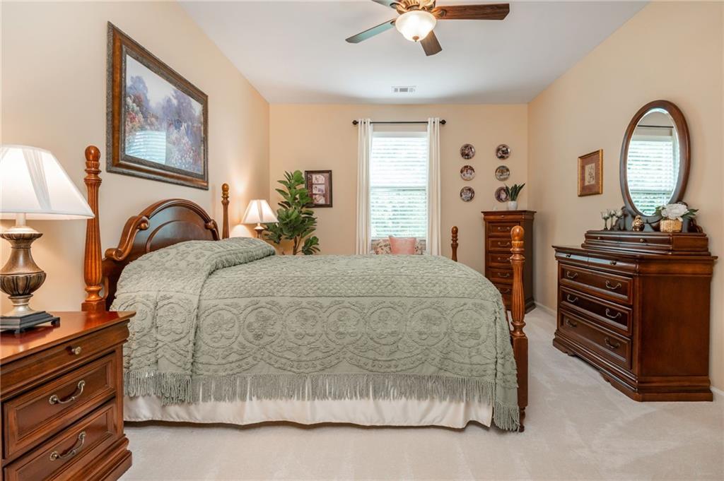 407 Ward Farm Drive Powder Springs, GA 30127 - Photo 30 of 67 a bedroom with a bed and a chandelier