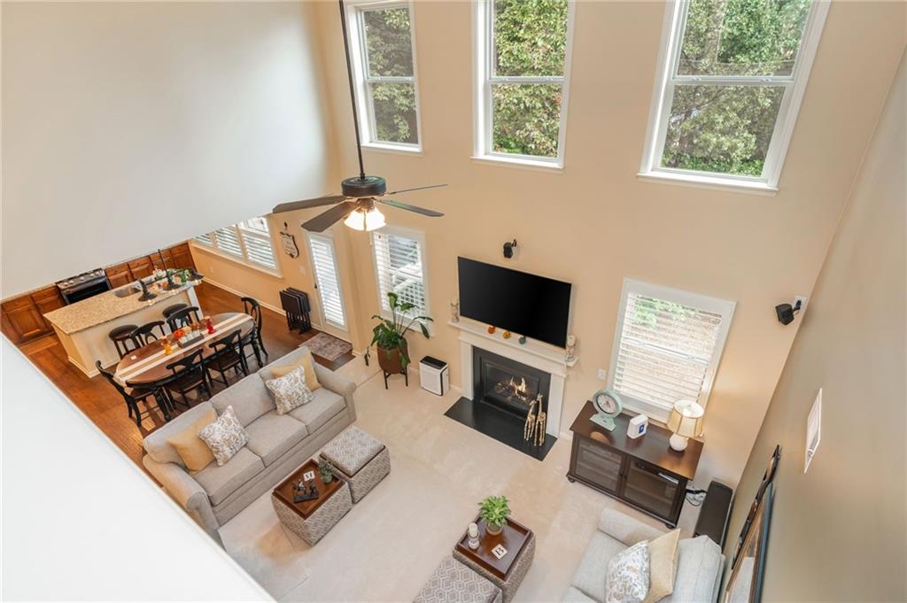 407 Ward Farm Drive Powder Springs, GA 30127 - Photo 32 of 67 a living room with furniture a flat screen tv and a window