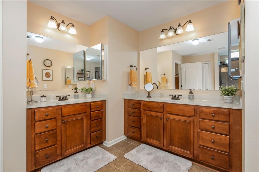 407 Ward Farm Drive Powder Springs, GA 30127 - Photo 38 of 67 a spacious bathroom with a granite countertop double vanity sink a mirror and a