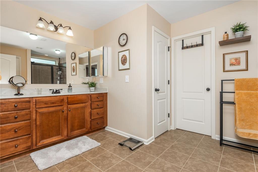 407 Ward Farm Drive Powder Springs, GA 30127 - Photo 41 of 67 a spacious bathroom with a mirror sink and shower