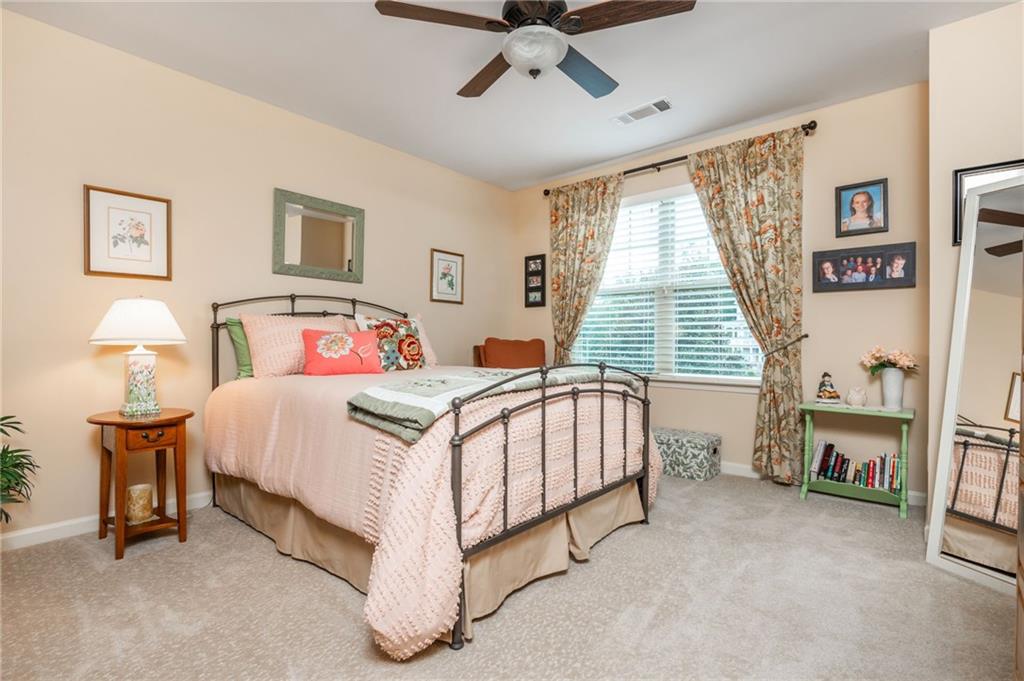 407 Ward Farm Drive Powder Springs, GA 30127 - Photo 42 of 67 a bedroom with a bed and a chandelier