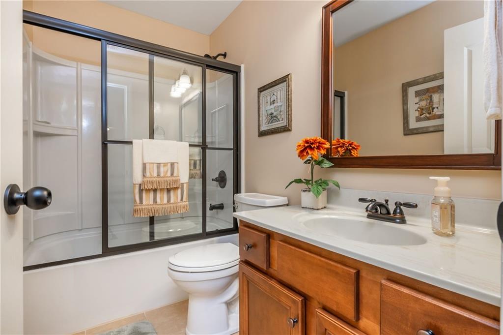 407 Ward Farm Drive Powder Springs, GA 30127 - Photo 43 of 67 a bathroom with a sink a toilet and shower