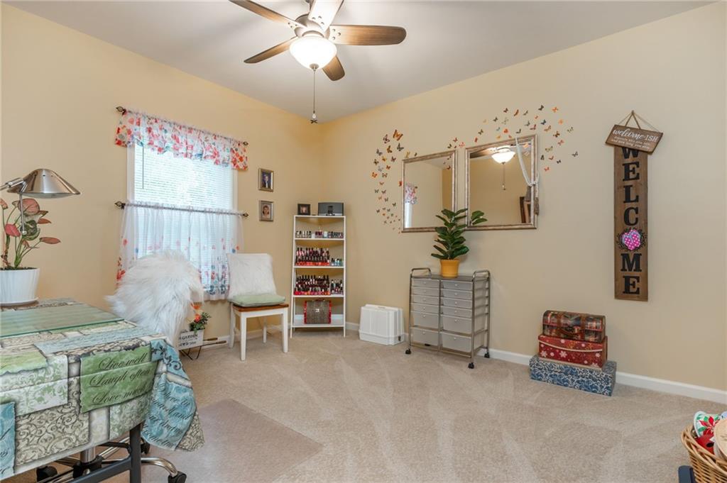 407 Ward Farm Drive Powder Springs, GA 30127 - Photo 48 of 67 a living room with furniture and a chandelier