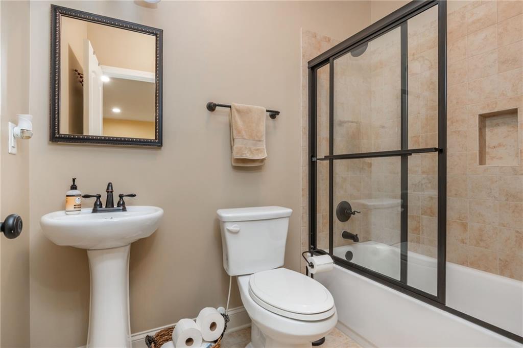 407 Ward Farm Drive Powder Springs, GA 30127 - Photo 49 of 67 a bathroom with a sink mirror toilet and shower