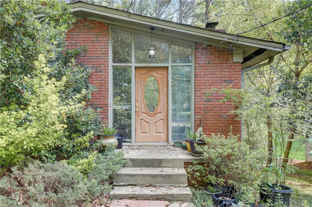 364 West Wieuca Road Northeast Atlanta, GA 30342 - Photo 1 of 1 a front view of a house with garden