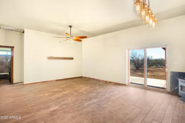 a view of a room with wooden floor