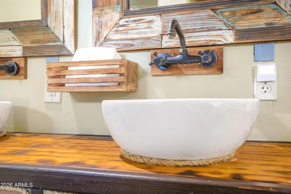 a bathroom with a granite countertop toilet sink and mirror