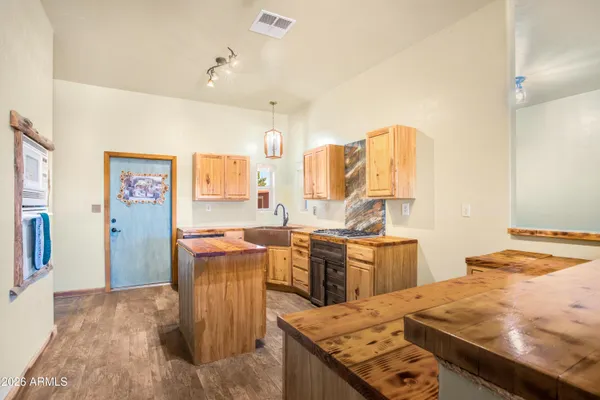 a kitchen with stainless steel appliances granite countertop a sink and a stove