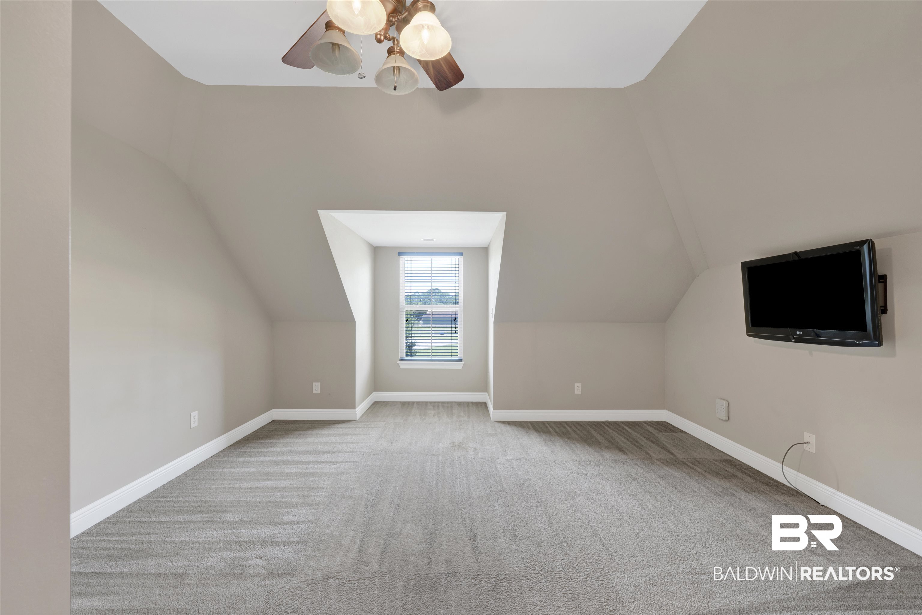 12944 Anna's Way Stapleton, AL 36578 - Photo 57 of 64 Spacious room featuring vaulted ceilings, a window with horizontal blinds, neutral-toned carpeting, and a ceiling fan with light fixtures