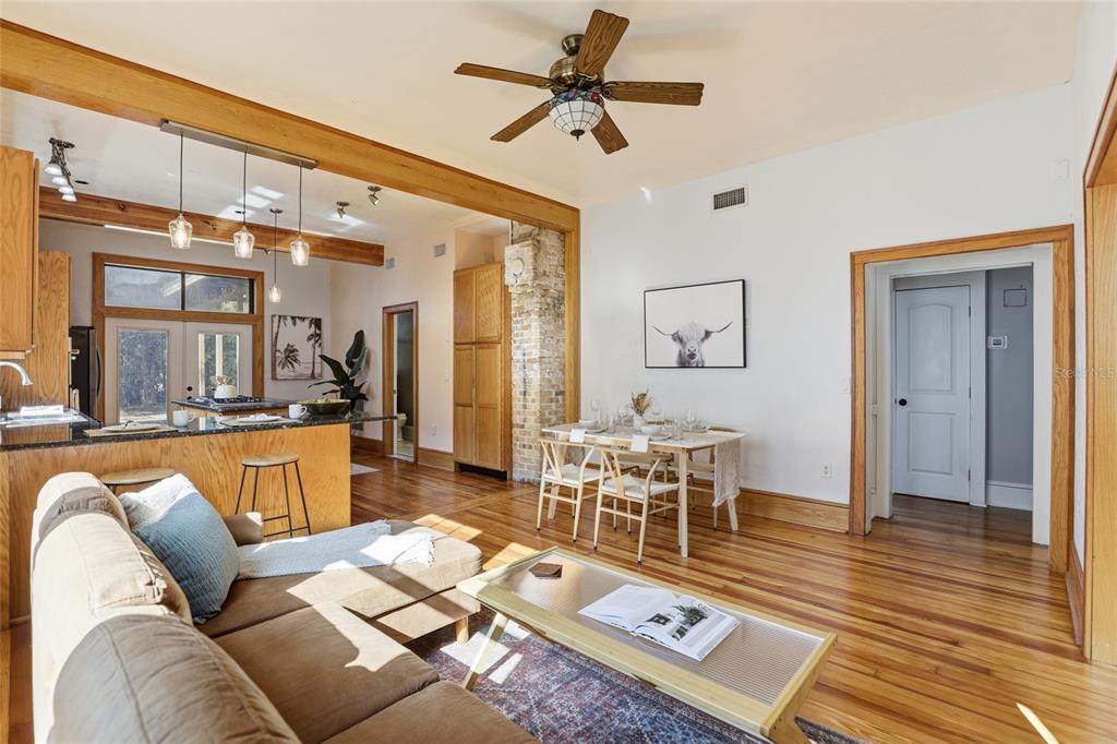 216 Northeast 6th Street Gainesville, FL 32601 - Photo 12 of 36 a living room with furniture a rug and a chandelier
