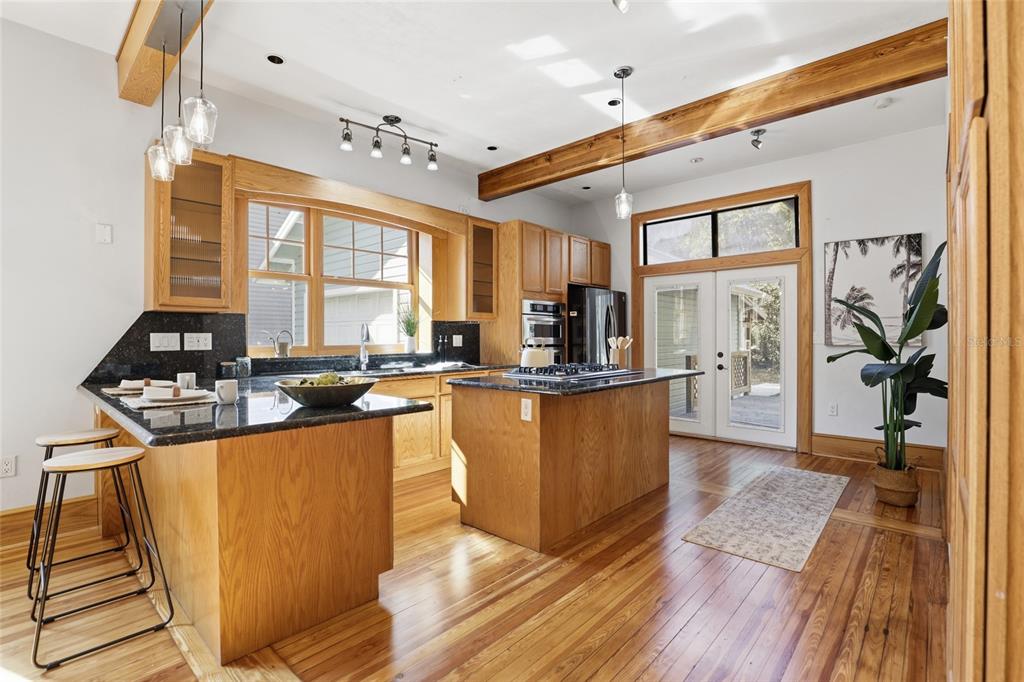 216 Northeast 6th Street Gainesville, FL 32601 - Photo 13 of 36 a kitchen with stainless steel appliances granite countertop a sink a stove and a refrigerator