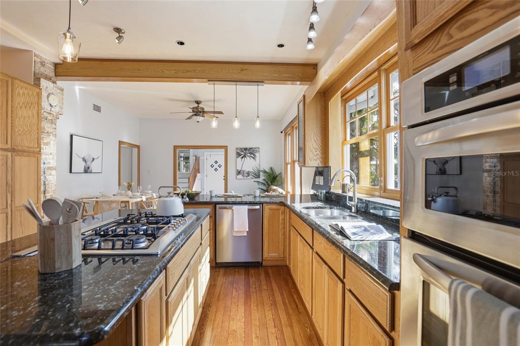 216 Northeast 6th Street Gainesville, FL 32601 - Photo 15 of 36 a kitchen with stainless steel appliances granite countertop a stove and a sink