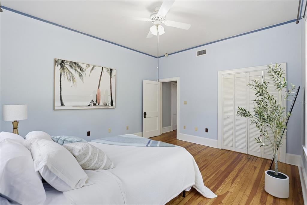 216 Northeast 6th Street Gainesville, FL 32601 - Photo 19 of 36 a bedroom with a bed and a potted plant