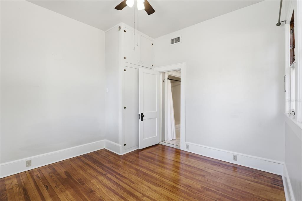 216 Northeast 6th Street Gainesville, FL 32601 - Photo 24 of 36 a view of an empty room with wooden floor