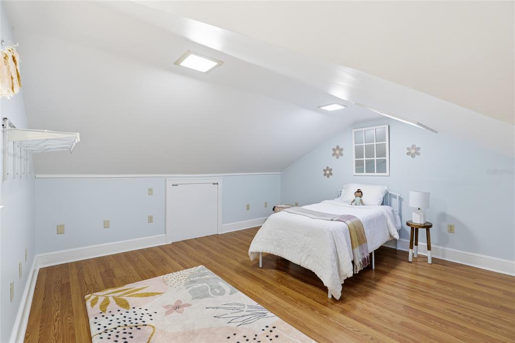 216 Northeast 6th Street Gainesville, FL 32601 - Photo 25 of 36 a bedroom with a bed and a night stand