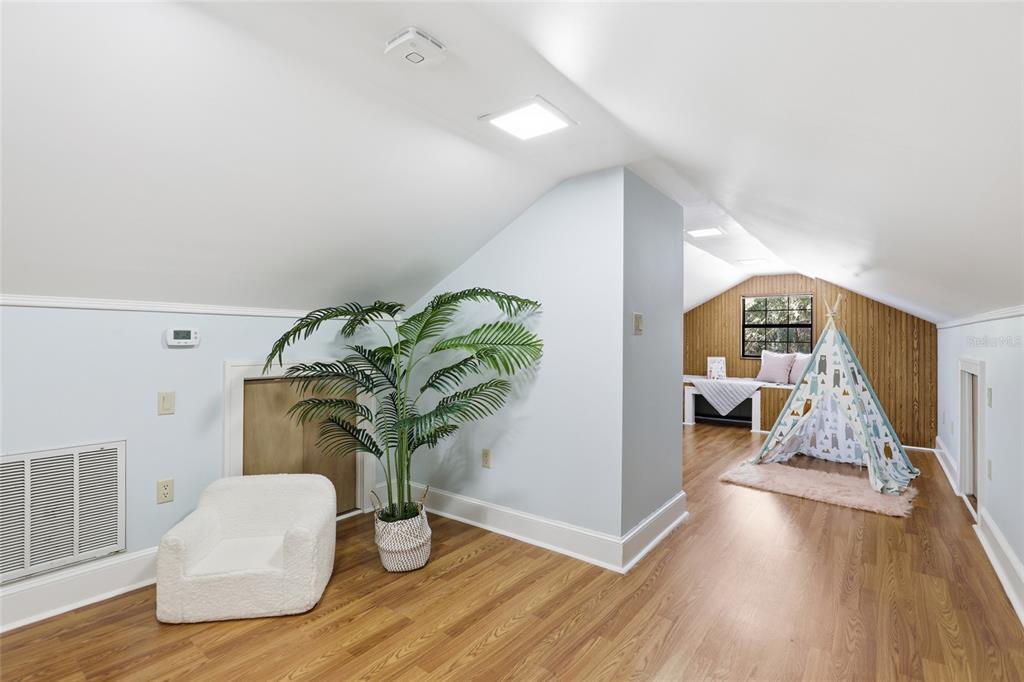 216 Northeast 6th Street Gainesville, FL 32601 - Photo 27 of 36 a living room with furniture flowerpot and wooden floor